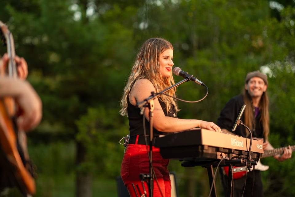 Izzy joy playing performing on stage
